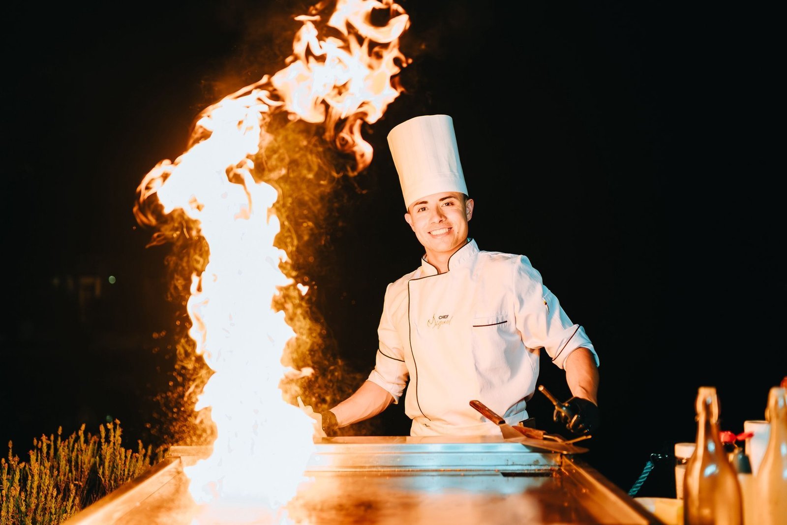 A burst of flame rising from the teppanyaki grill
