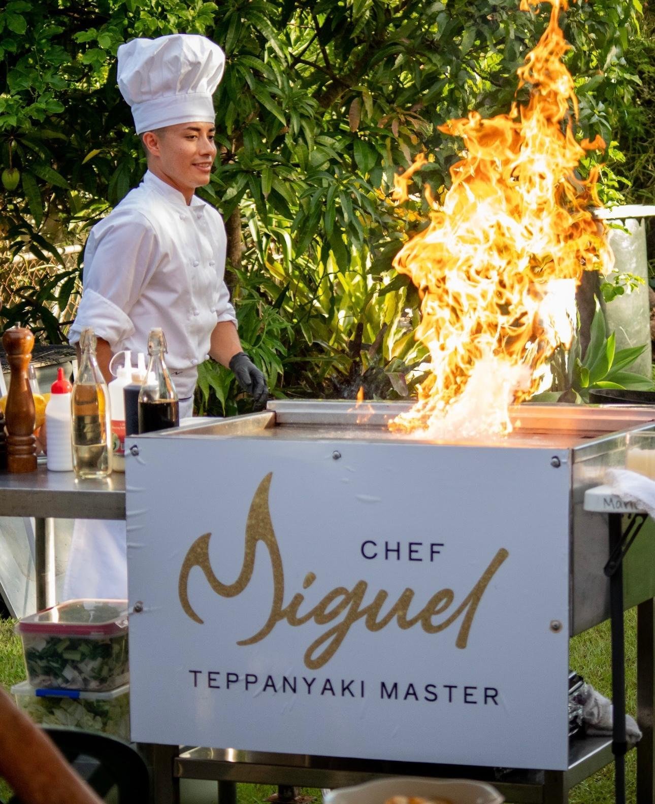Chef Miguel cooking on the grill at a garden event