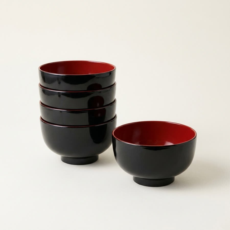 The bowls nested into one stack beside a single bowl