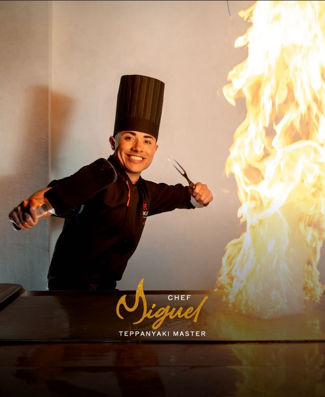 Chef Miguel performing with a tall teppanyaki flame
