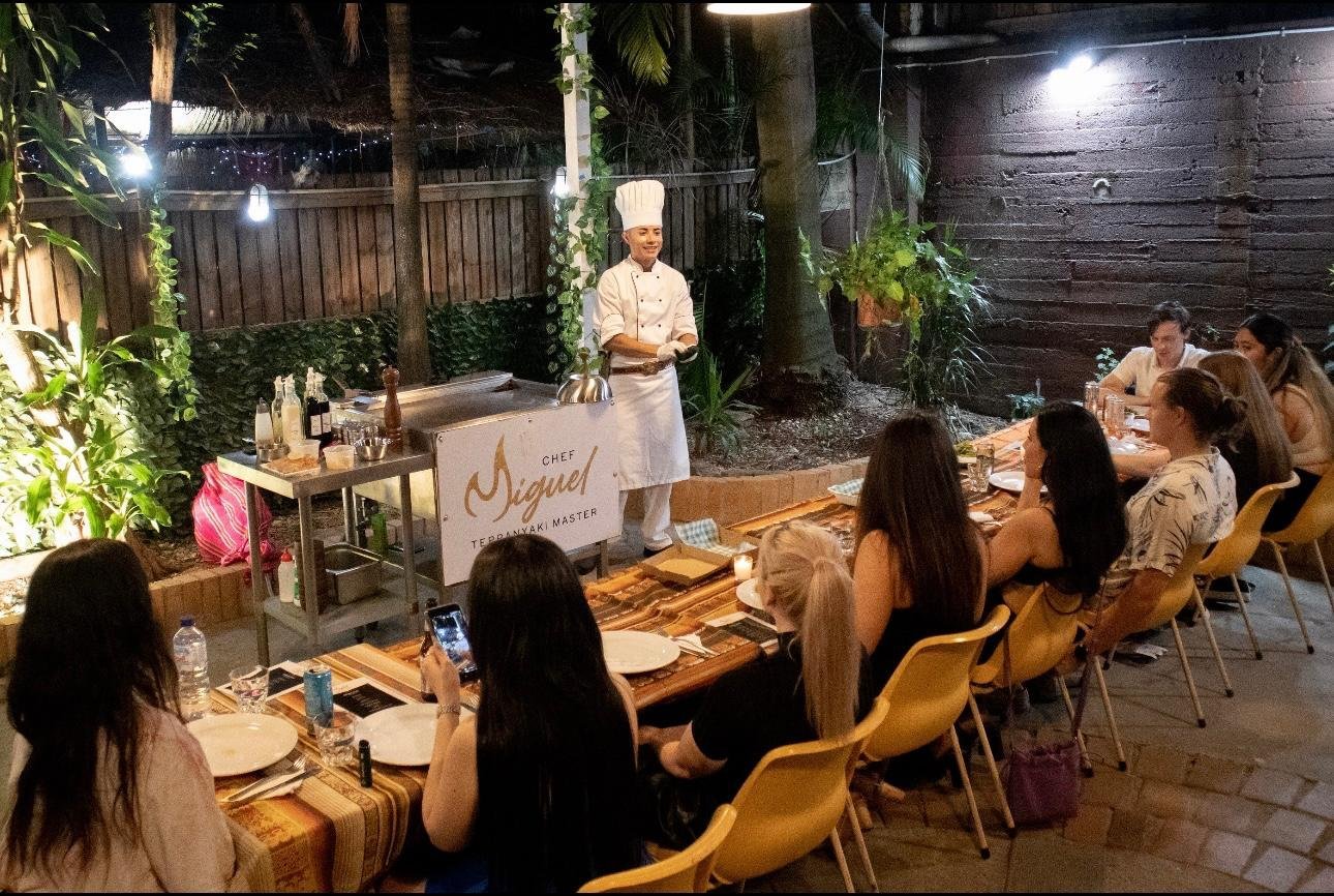 Guests seated around the table at a Chef Miguel house party